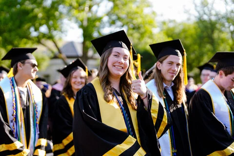 students celebrating in commencement robes