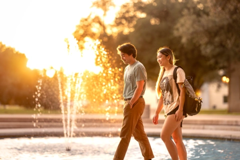 Students walking with SU banners